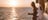 Two women standing at a rail watching the sunset on the Darwin Harbour Cruise tour