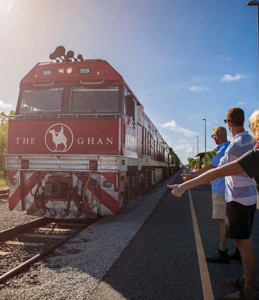 Three people waiting for the Ghan to pull up