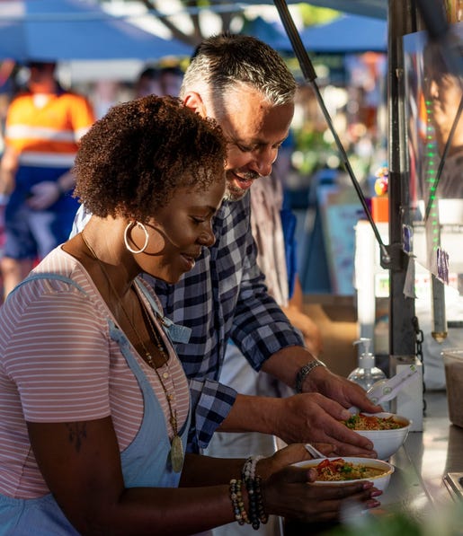 couple eating laksa at parap market