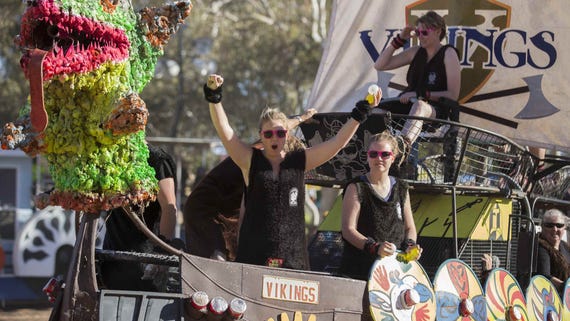 People on a boat at the Henley on Todd Regatta in Alice Springs