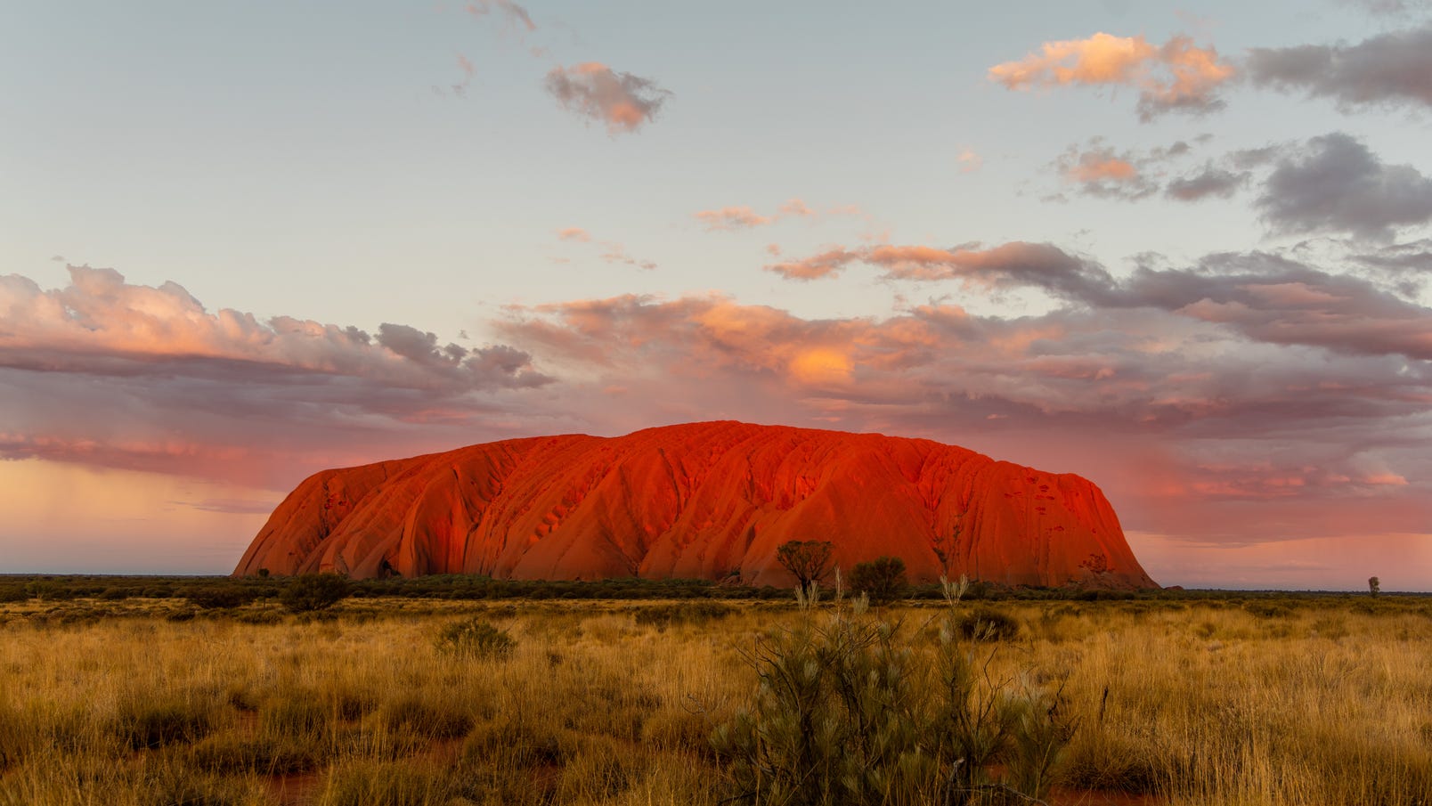 Uluru set amongst an outback sunset