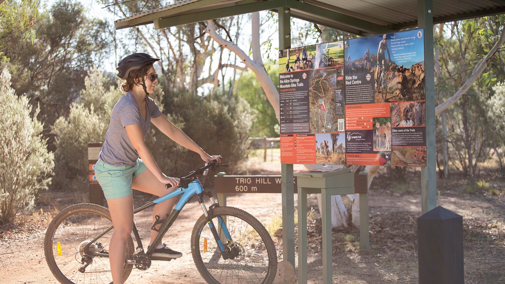 A cyclist reading Telegraph MTB trail sign