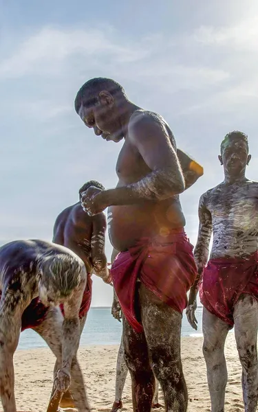 groupofaboriginalpeoplewithbodypaintonthebeachinarnhemland-1jpg
