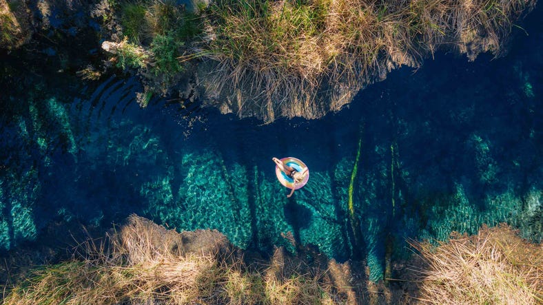 Woman floating on a tube down Bitter Springs