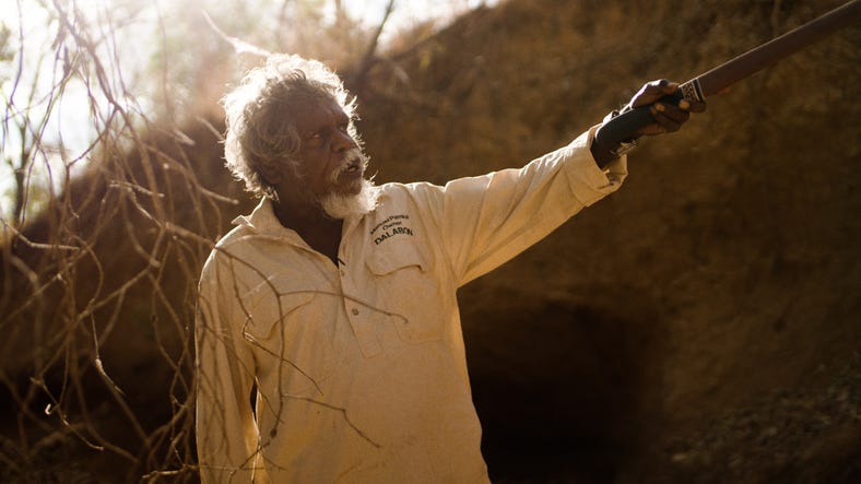 Man pointing to rock art