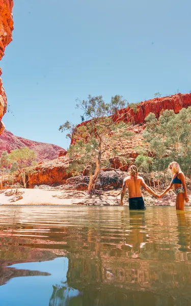 Couple standing in the water at Ormiston Gorge