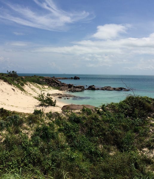 view of the white sand beach and clear water at banu banu
