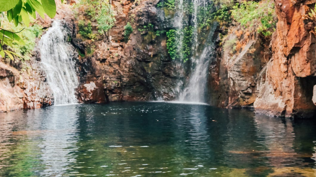 Florence Falls and the clear waters of the waterhole in front of them