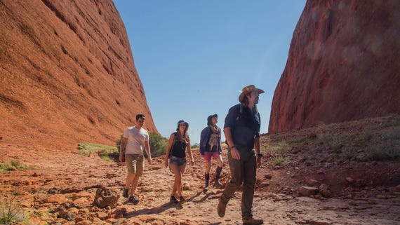 A group of people walking the Valley of the Winds walk at Kata Tjuta