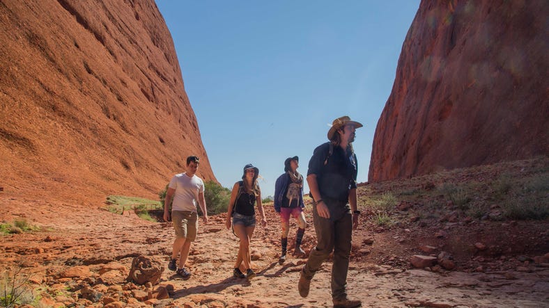 A group of people walking the Valley of the Winds walk at Kata Tjuta