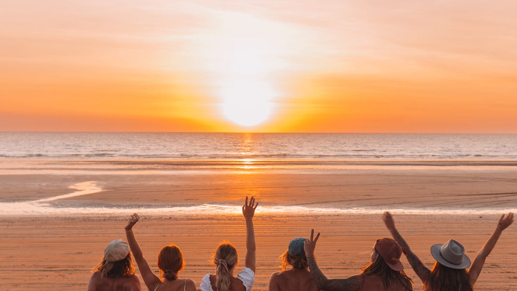 Friends watching sunset on the beach