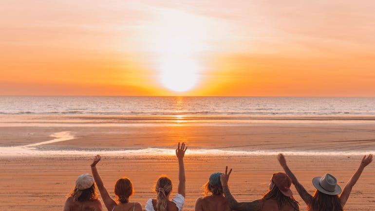 Friends watching sunset on the beach
