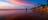 Girl standing on Casuarina Beach at sunset