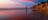 Girl standing on Casuarina Beach at sunset