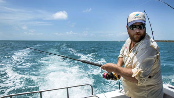 Man fishing on boat in Arnhem Land