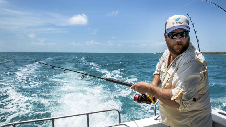Man fishing on boat in Arnhem Land