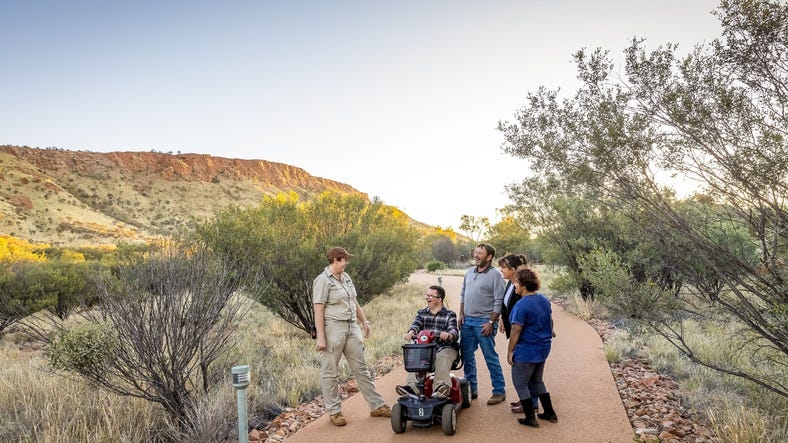 group of people listening to a guide at the Alice Springs Desert Park