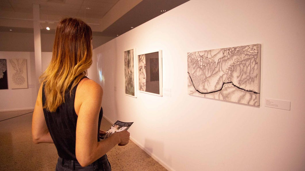 Girl looking at painting on the wall at Godinymayin Yijard Rivers Arts and Culture Centre