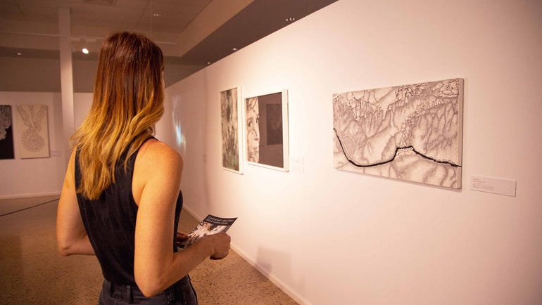 Girl looking at painting on the wall at Godinymayin Yijard Rivers Arts and Culture Centre