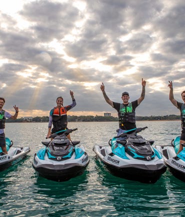 Four people standing on jetskis from 007 Jetski