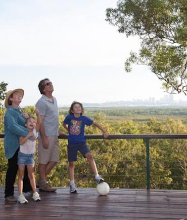 Family plays at Charles drwin National Park and relax by looking out over Darwin - community recreation
