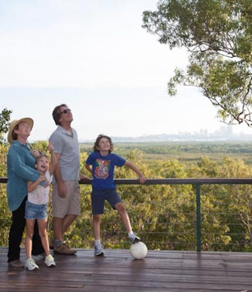 Family plays at Charles drwin National Park and relax by looking out over Darwin - community recreation
