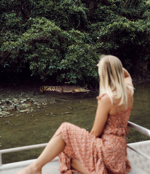 A woman watching a crocodile from Billabong cruise
