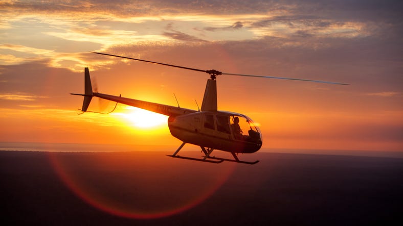 Helicopter in flight at sunset