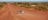 Car driving down red dirt road in Central Australia