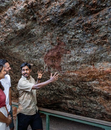 tour guide showing couple nourlangie rock art in kakadu national park