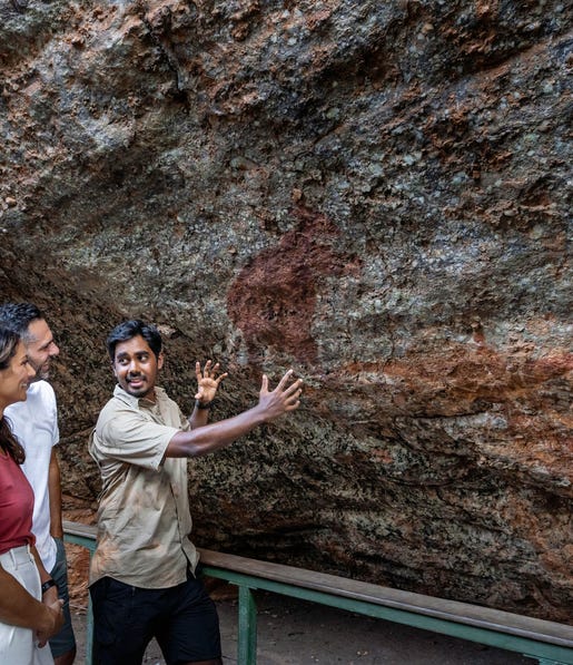 tour guide showing couple nourlangie rock art in kakadu national park