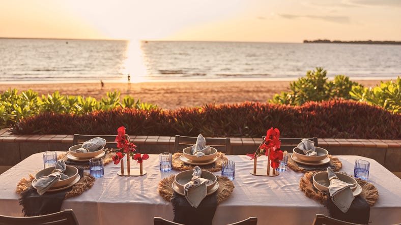A table by the beach at sunset at Darwin Sailing Club