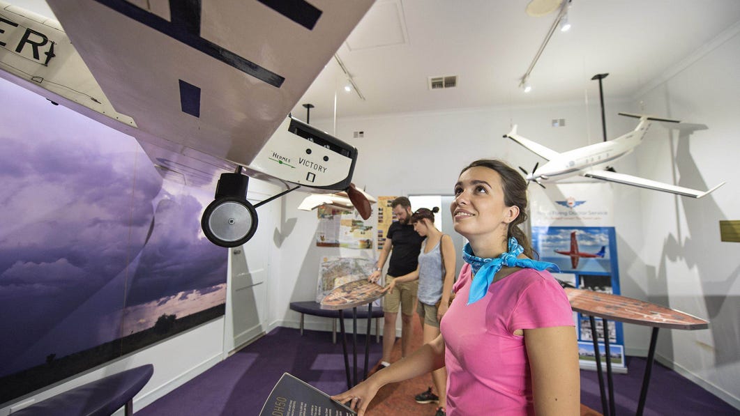 Girl looking at a plane model at the Royal Flying Doctor Service Tourist Facility