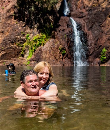 A couple swimming at Wangi Falls in Litchfield National Park