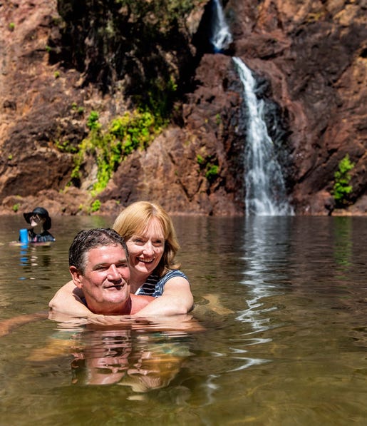 A couple swimming at Wangi Falls in Litchfield National Park