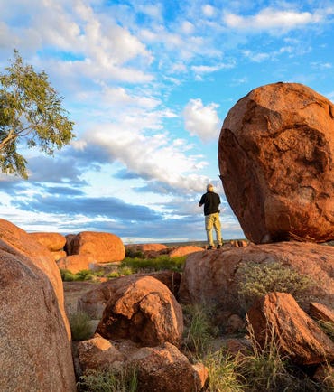 Man standing at Karlu Karlu Devils Matbles near Tennant Creek