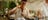 A_bartender_making_a_drink_and_smiling_with_his_colleague_behind_a_bar.jpg