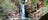 A woman sitting in front of the waterfall at Southern Rockhole near Katherine