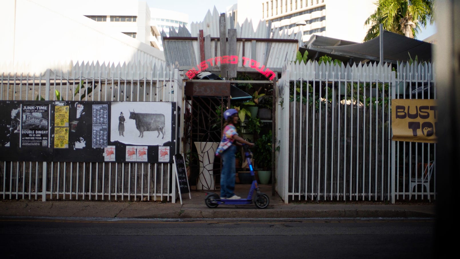 woman on scooter near bar