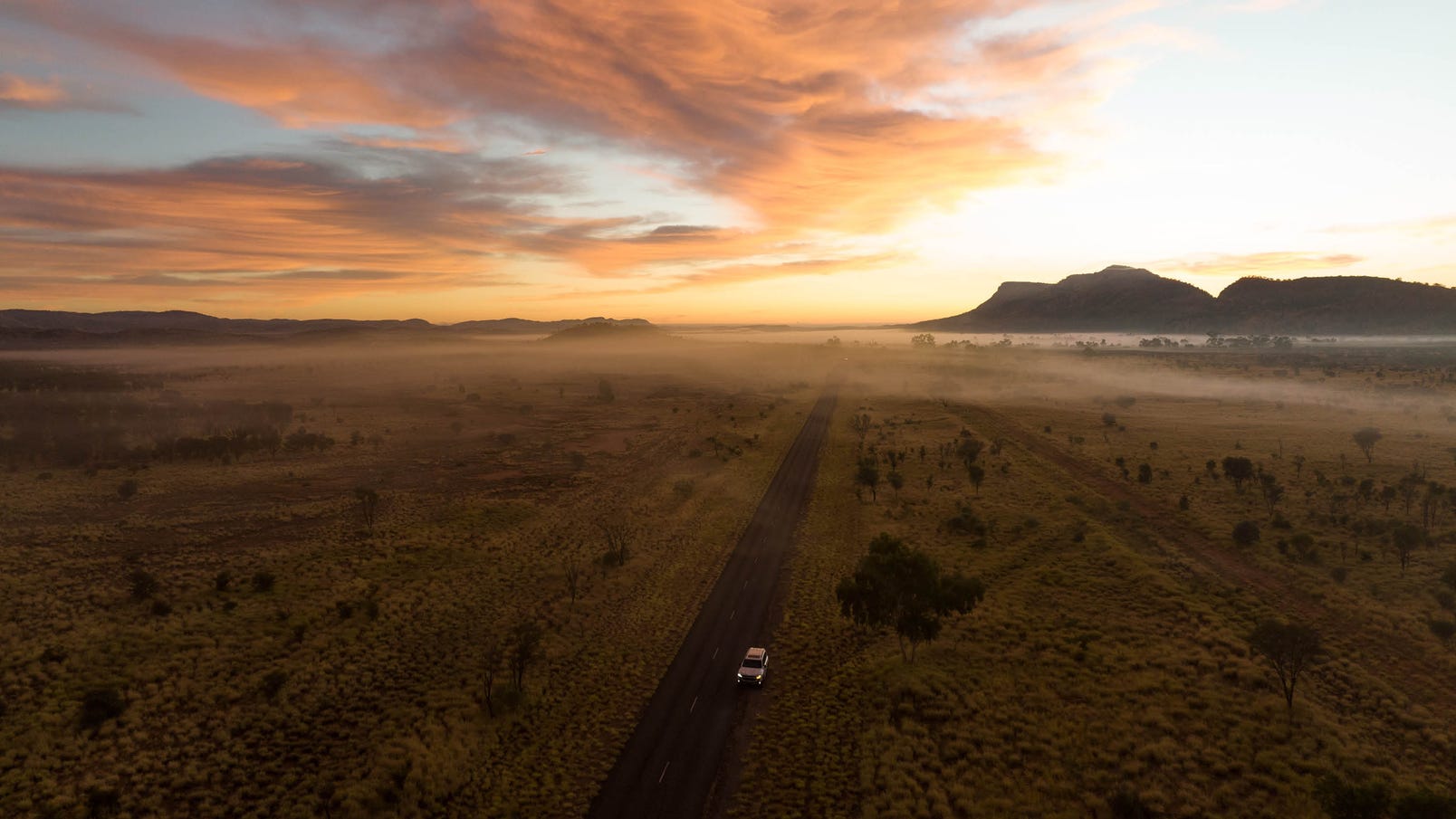driving through the west macdonnell ranges at dusk