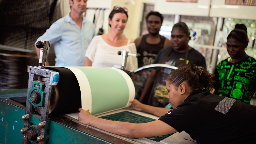 visitors watching screen printing at the buku-larrnggay mulka centre