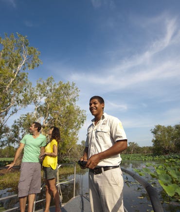 A couple and Aboriginal tour guide on a cruise at Yellow Water