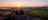 Three people sitting on a rock in Ubirr and watching the sunset