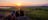 Three people sitting on a rock in Ubirr and watching the sunset