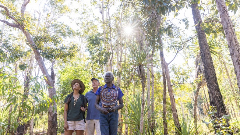 Three people walking through the bush