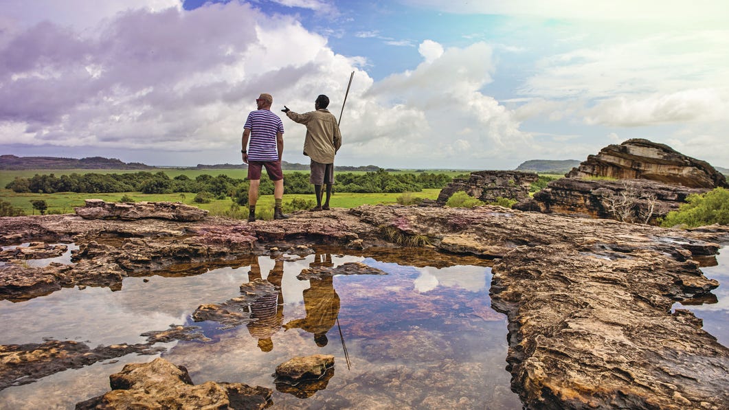 A visitor and Aboriginal tour guide at Ubirr lookout.jpg