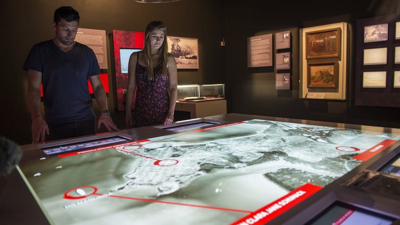 Visitors viewing the Defence of Darwin display at the Darwin Military Museum