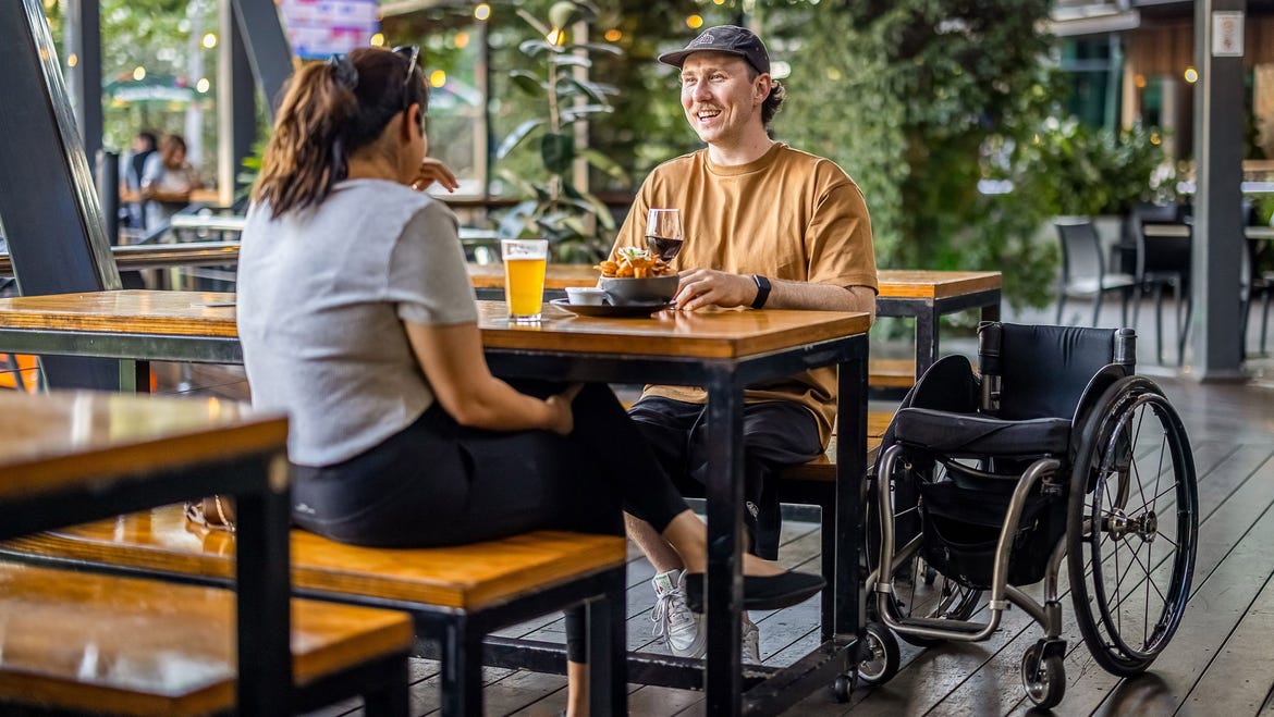 two friends eating drinking precinct