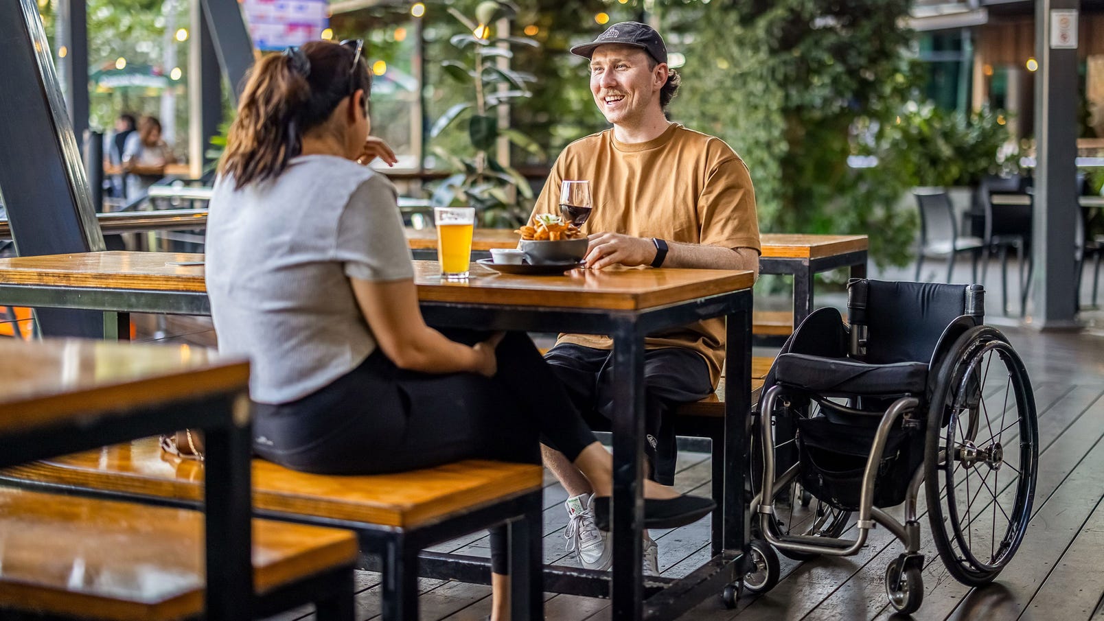 two friends eating drinking precinct