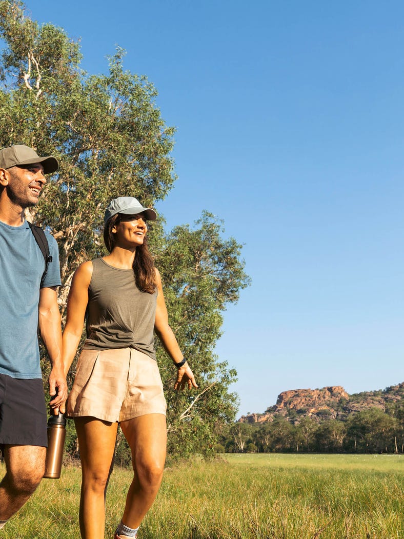 couple walking through anbangbang in kakadu national park